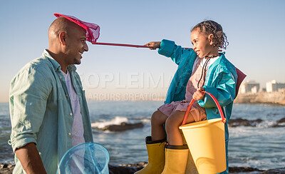 Buy stock photo Family fun, girl and father at a beach for learning, playing and collect seashell along the sea, happy and smile against blue sky. Happy family, water and child with dad at the ocean, relax and play