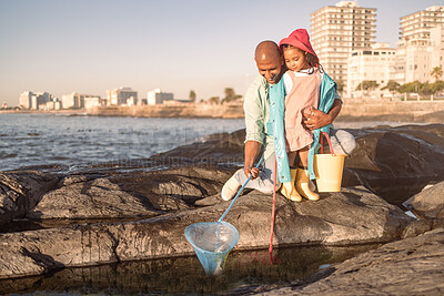 Buy stock photo Happy, beach and girl fishing with her father, teaching and learning by the water in Philippines. Travel, bonding and child catching fish with dad in a natural pool by the rocks at the sea on holiday