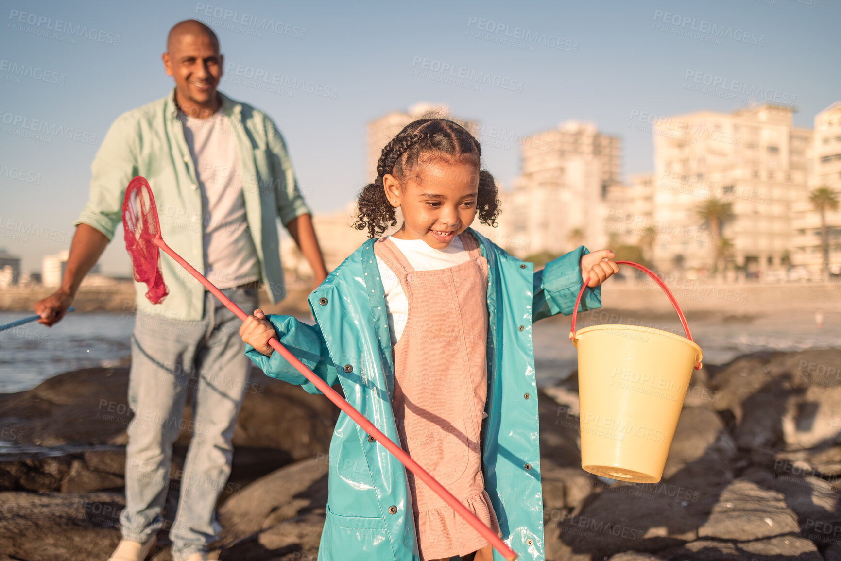 Buy stock photo Fishing, bonding and child with father at beach for adventure, happy and holiday in Australia. Nature, catch fish and girl on vacation with dad for conservation on the rocks by the sea with a smile