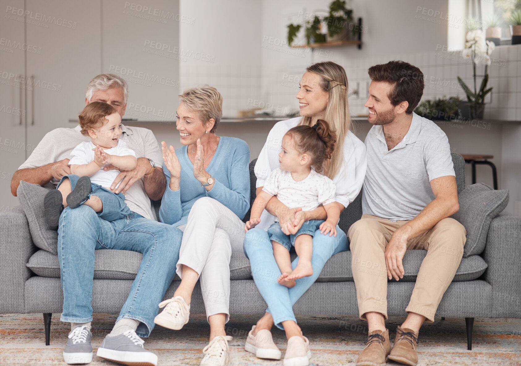 Buy stock photo Big family, love and relax on sofa in home living room, bonding and enjoying quality time together. Support, care and grandma and grandpa playing with baby and having fun with mother, father and girl