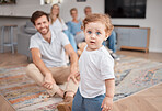 Baby, portrait and play in living room with family, curious and energy, cute and little with dad, mom and grandparents. Boy , mother and father bonding in lounge with grandmother and grandfather 