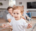 Baby, learning and walk in family home with toys, education and parents in living room. Child, infant and walking with happy family, happiness and balance on floor, carpet and blurred background