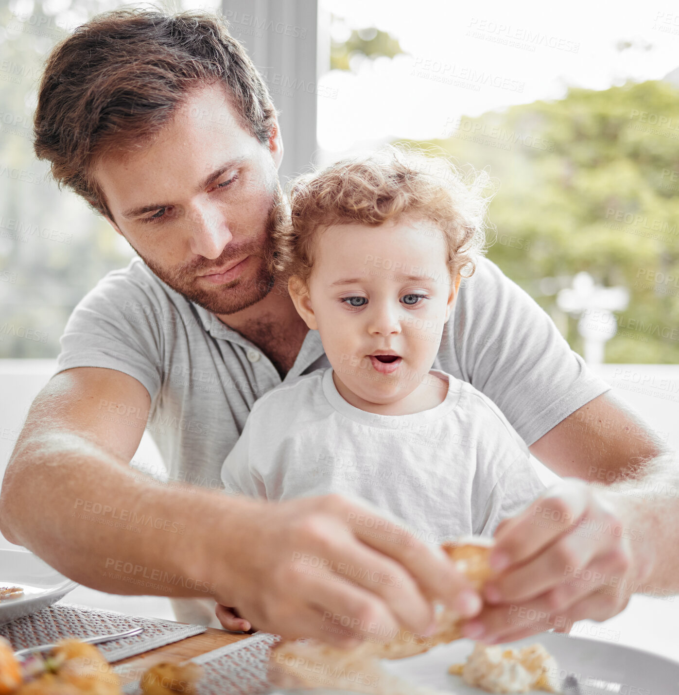 Buy stock photo Feeding, lunch and child eating bread with father and hungry together with food at the dining room table. Dinner, meal and dad with breakfast for baby in the morning in their family house with love