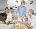 Family, food and celebration with a senior man and woman at a dinner table with their son and daughter for lunch. Dish, plate and love with male and female in a retirement home to visit their parents