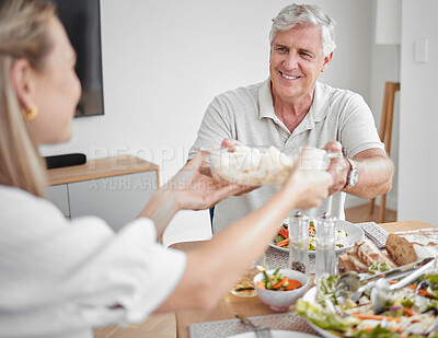 Buy stock photo Thanksgiving, dinner and family pass food at table enjoying festive celebration together at home. Love, family home and grandfather giving dish to woman at lunch, supper and meal in dining room