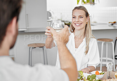 Buy stock photo Couple, toast and lunch for romantic date in the family home while relaxing with love and care. Anniversary, meal and cheers with a man and woman drinking wine while eating at home to celebrate 