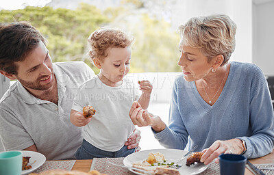 Buy stock photo Family, food and eating with baby while feeding healthy diet or nutrition in the family lunch in home. Grandmother, child and dad with hungry boy kid and eat lunch or meal for health and wellness
