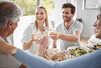Family toast, drink celebration or birthday lunch with smile, happy or love for birthday, achievement or success in home. Toast, alcohol and champagne in family home with man, woman or senior parents