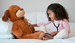 Teddy bear, learning and child with stethoscope for healthcare, heart and anatomy education in her bedroom and home for development. Girl play with hospital, doctor or nurse cardiology toys or tools