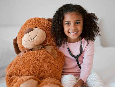 Buy stock photo Stethoscope, teddy bear and girl with a child her stuffed animal with a smile in her house. Portrait of happy female kid holding a fluffy toy, learning to be a doctor or pediatrician in healthcare