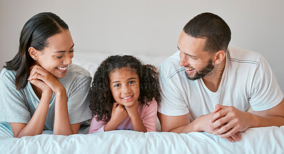 Buy stock photo Family, portrait and home with a parents relax and resting with their little girl in the family home. Mother, father and daughter for caring, loving and bond relationship in the bedroom 