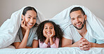 Relax, happy and girl with her parents in bed for security, love and safety under blanket in their family home. Support, smile and portrait of a child with her mother and father in the bedroom