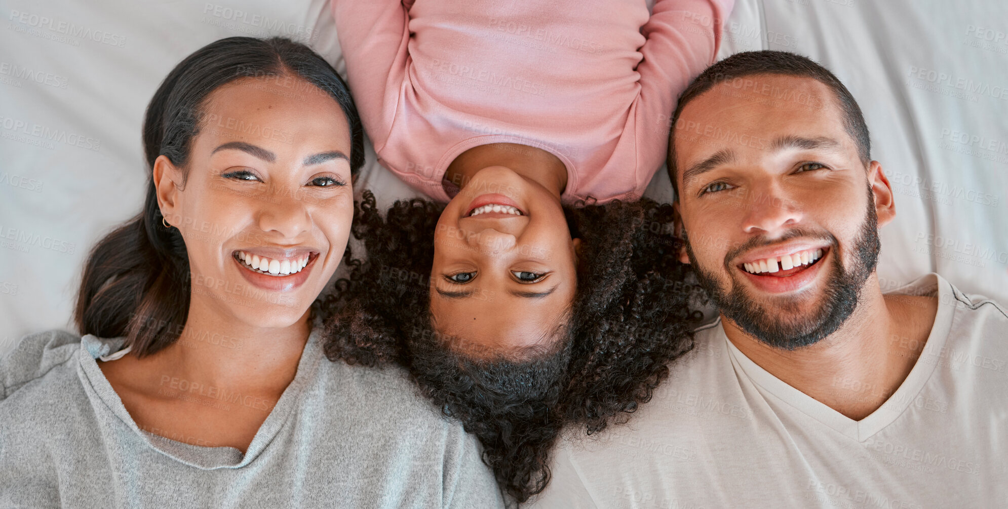 Buy stock photo Love, bed and portrait of black family relax at home for peace, bonding and enjoy morning quality time together. Bedroom, smile and happy family face of African mother, father and kid girl top view