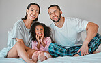 Dad, mom and child relax on bed together with happy smile, morning peace and bonding in bedroom of home. Portrait of family love, mother and girl kid hug with father for support, security and caring 