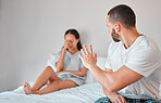 Couple, angry and marriage fight, divorce and stress in bed with mental health, abuse and mistake in relationship. Frustrated, mad and man argument and conflict with woman for infidelity in home
