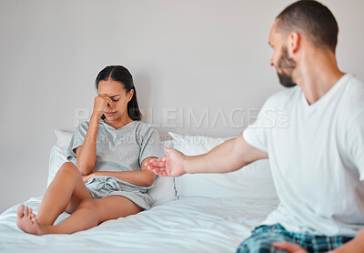 Buy stock photo Comfort, crying and sad couple in bed after fight, argument and disagreement at home. Love, marriage and young man reaching to console upset and depressed woman sitting in bedroom to fix relationship