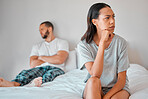 Couple, fight or divorce for angry woman on bed in house, home or hotel bedroom in cheating affair, scandal or argument. Frustrated, mad or annoyed wife and man in stress, burnout or marriage crisis