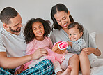 Happy family, love and bedroom with child, baby and parents together on a bed for care, bonding and quality time at home. Portrait of kids, man and woman in Puerto Rico house to relax and connect