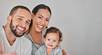 Family, love and happiness portrait with baby for support, care and qaulity time together in studio. Happy, smile and parents with child for relationship bonding or memory picture in grey background