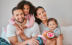 Bonding, care and smile from family in the bedroom with love, peace and relax together in the morning. Happy, affection and portrait of a mother and father with their girl children in bed for rest