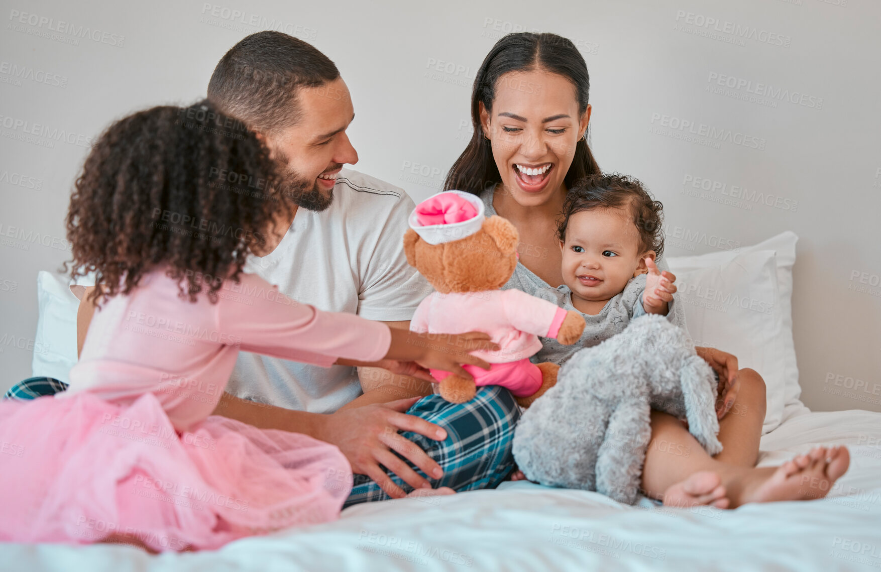 Buy stock photo Family, morning and children on bed bonding with teddy bear for happiness, care and togetherness. Happy family, relax and siblings play together in bedroom with smile of baby, mother and dad.


