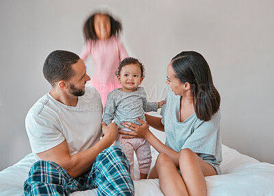 Buy stock photo Family, baby and girl jump on bed in bedroom, having fun or playing. Support, love and care of happy father, mother and children bonding, smiling and enjoying quality time together in family house.