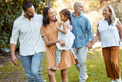 Buy stock photo Family, walking and together in park with love and spending quality time outdoor, for bonding and care. Grandparents, parents and child walk, happy in nature and happy family generations.