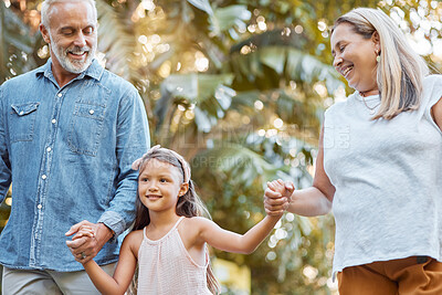 Buy stock photo Park, holding hands and grandparents with child for outdoor walking, nature wellness and development in summer, holiday and travel. Happy girl with senior family in garden bonding together with love