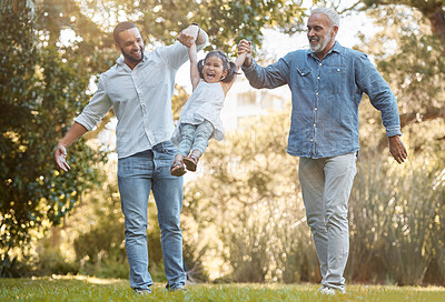 Buy stock photo Diverse, family and playing in a park for fun, bonding and love in summer with a father, grandfather and daughter. Garden, big family and interracial family swinging little girl play with joy 