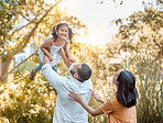 Family, nature and girl in air for lift, love and support bonding together. Happy, excited kid and parents, happiness and relax or child development lifestyle for quality time in nature outdoor