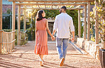 Couple, holding hands and outdoor on travel date for love, care and happiness together in nature park while talking, bonding and walking in summer. Man and woman having conversation about marriage