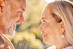 Mature, couple and face for bonding, love and care romantic relationship in a summer garden. Old man and woman in love in retirement for bond, caring and honeymoon affection in a park in spring