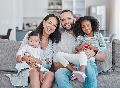 Buy stock photo Happy, smile and portrait of a family on a sofa relaxing, bonding and sitting together in the living room. Mother, father and children resting on the couch with love, care and happiness at their home