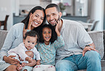 Happy family, portrait and love for relax on sofa together or quality time, support and relationship care in family home. Parents smile, excited children and happiness on couch in house living room