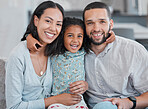 Girl, mother and happy father, portrait and relax on sofa, love and care with smile in family home together. Family, parents and child hug, happiness and laugh with support on couch in family home