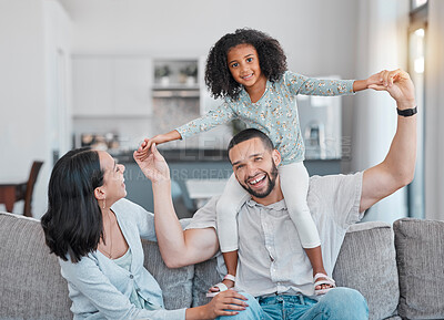 Buy stock photo Portrait, family and parents with girl playing in living room at home. Adorable smiling girl bonding with mother and father or play fly or happy couple and child together in family home in brazil