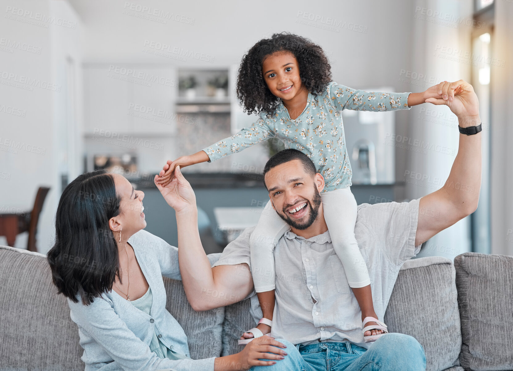 Buy stock photo Portrait, family and parents with girl playing in living room at home. Adorable smiling girl bonding with mother and father or play fly or happy couple and child together in family home in brazil