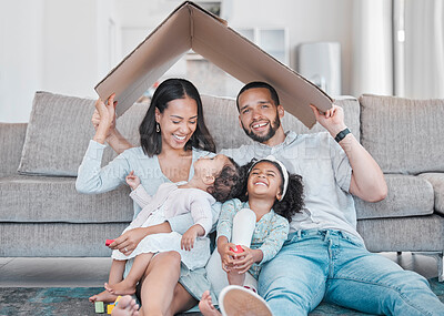 Buy stock photo Family, children and insurance with a mother, father and daughter siblings in a living room of their home together. Security, safety and homeowner with parents holding cardboard to cover sister kids