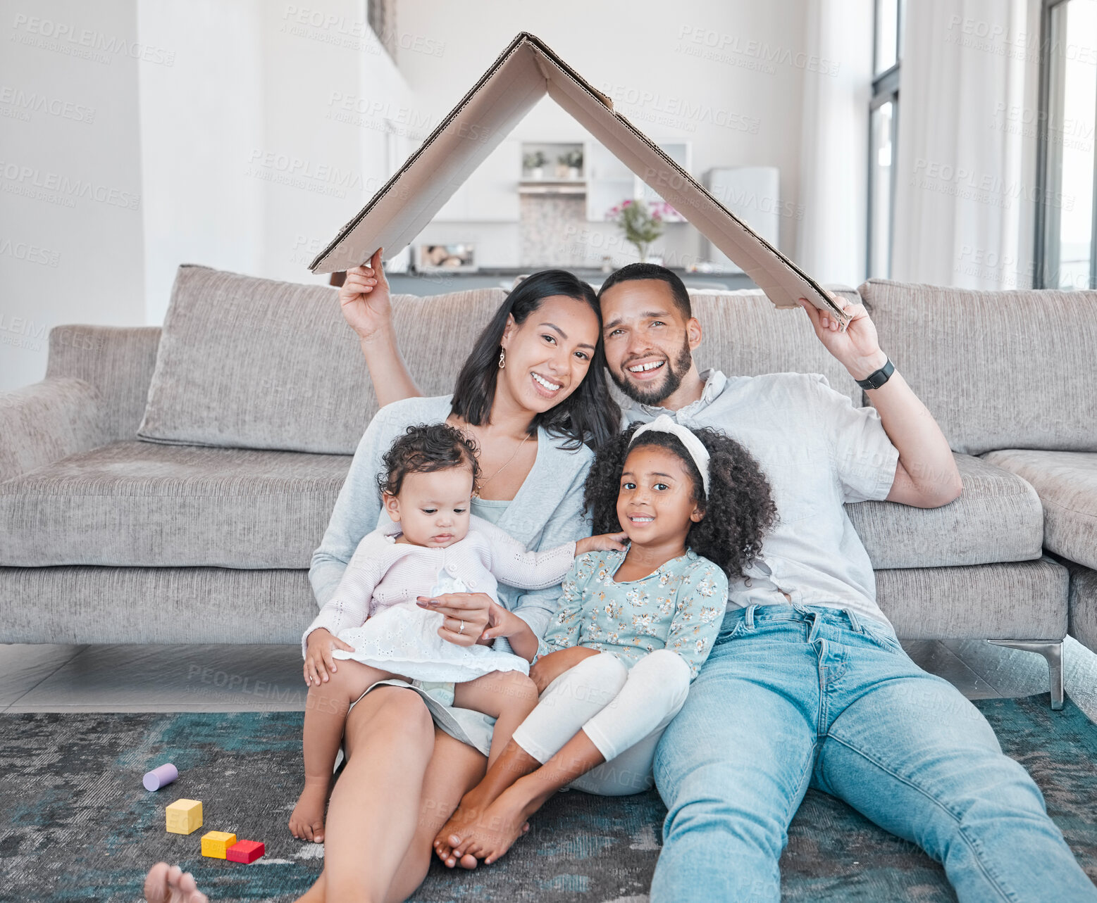 Buy stock photo Happy family with kids in living room of new family home, property and excited homeowners. Future, real estate and family security in home with mortgage for dad, mom and children with roof over head.