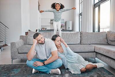 Buy stock photo Tired, parents and child jump on sofa with exhausted mother and father sitting on floor in living room. Family, energy and young girl jumping on couch with frustrated, annoyed and upset mom and dad 