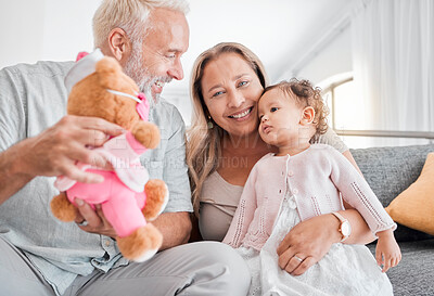 Buy stock photo Children, family and teddy bear with a girl and grandparents playing on the sofa during a visit in their home. Kids, love and toys with a senior man and woman bonding together with their grandchild