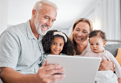 Buy stock photo Family, tablet and online browsing with senior people babysitting grandchildren in the family home. Grandfather, grandmother and grandkids with a digital tablet for streaming internet media