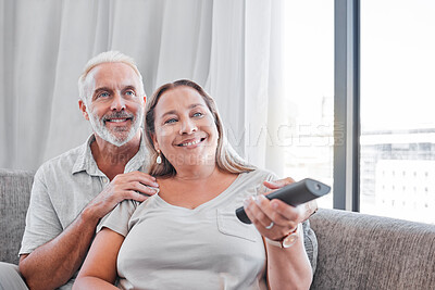 Buy stock photo Senior couple, watching tv and relax on sofa in living room together for happy retirement. Love, streaming television and elderly woman with retired man relaxing on couch, smile for comic movie 