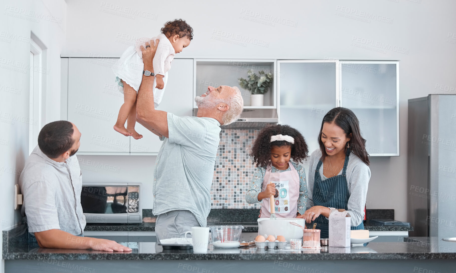 Buy stock photo Family, children and baking with a senior man bonding with his granddaughter in the kitchen of a home. Love, grandparent and diversity with a mother and daughter learning to bake for cooking