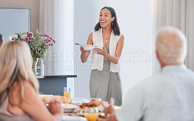 Woman, excited and serving family at thanksgiving dining table in house or home for celebration event, holiday or buffet party. Smile, happy or festive person with healthy food, meal or brunch bowl