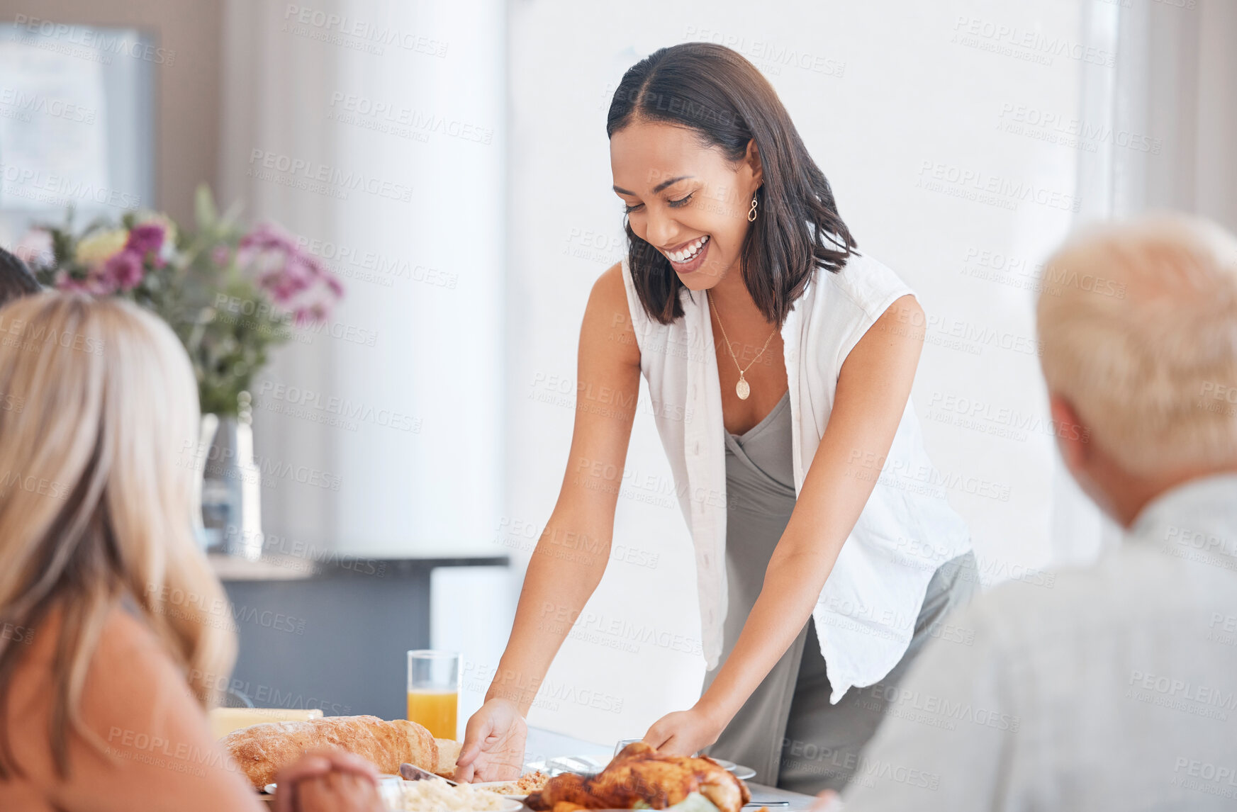 Buy stock photo Happy woman hosting food at dinner table in home, house and dining room for family lunch, meal and social gathering together. Party, celebration and eating in family home, lifestyle and happiness 