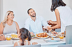 Happy family, bonding and thanksgiving meal at dining table in house, home or restaurant for holiday celebration. Smile, happy or festive man, women and children with traditional healthy food serving
