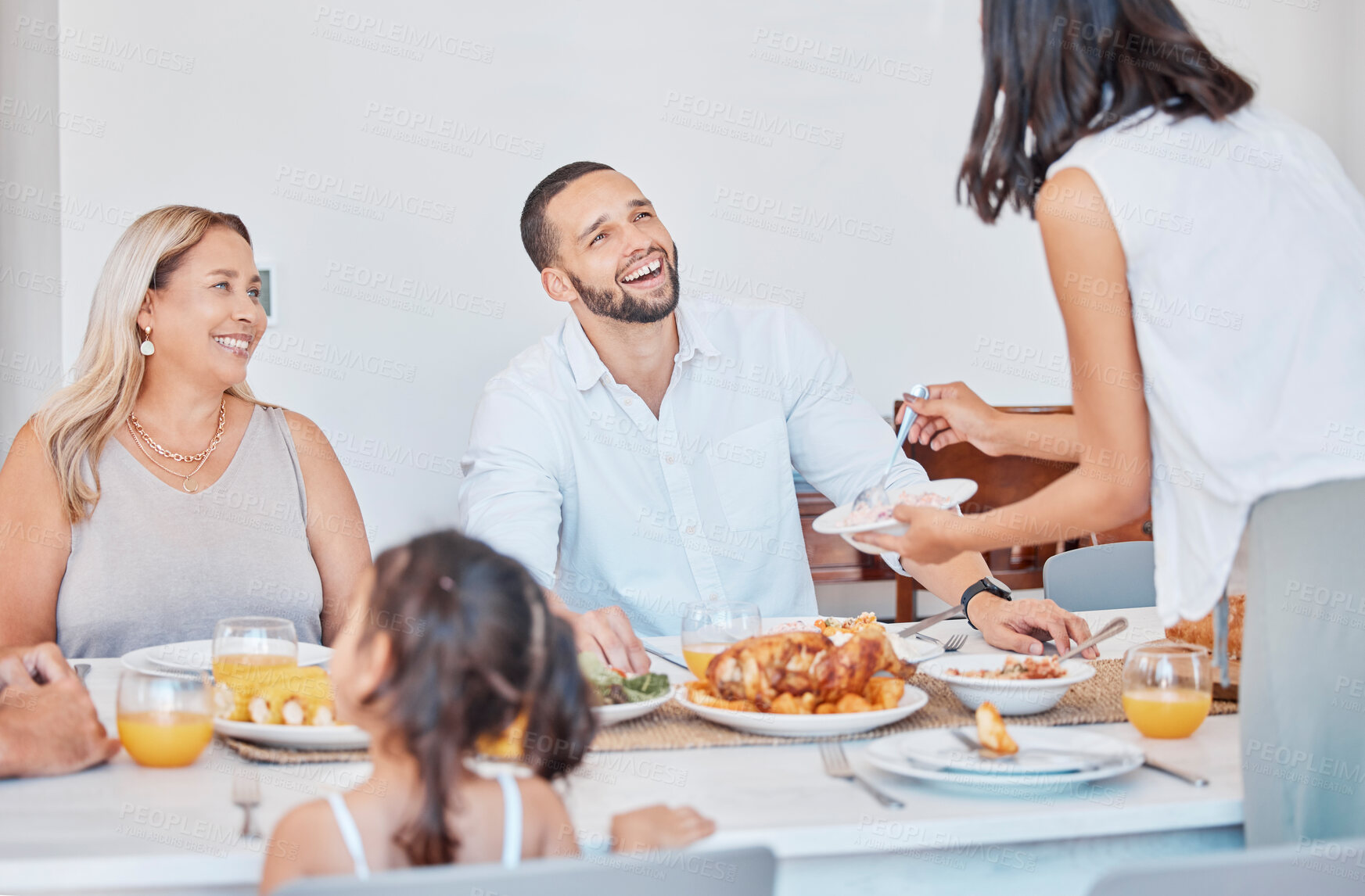 Buy stock photo Happy family, bonding and thanksgiving meal at dining table in house, home or restaurant for holiday celebration. Smile, happy or festive man, women and children with traditional healthy food serving