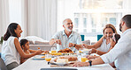 Family, happy and eating together, generations celebrate holiday or anniversary with food on table and dining room. Love, celebration and nutrition, grandparents with parents and children at home.