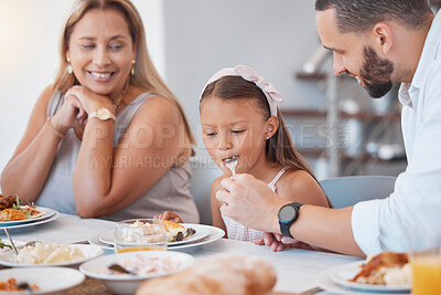 Buy stock photo Father, food and eating with child while feeding healthy diet or nutrition in the family lunch in home. Family, child and hungry little girl and grandmother eat lunch or meal for health and wellness